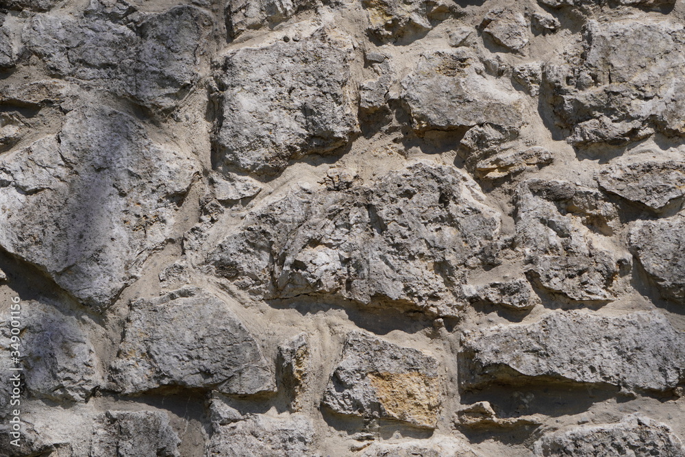 Fototapeta premium Stone wall, large gray stones, civil and industrial construction.
