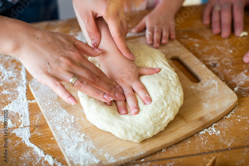 the family prepares the dough with hands and a rolling pin. Cook at home. stay home.