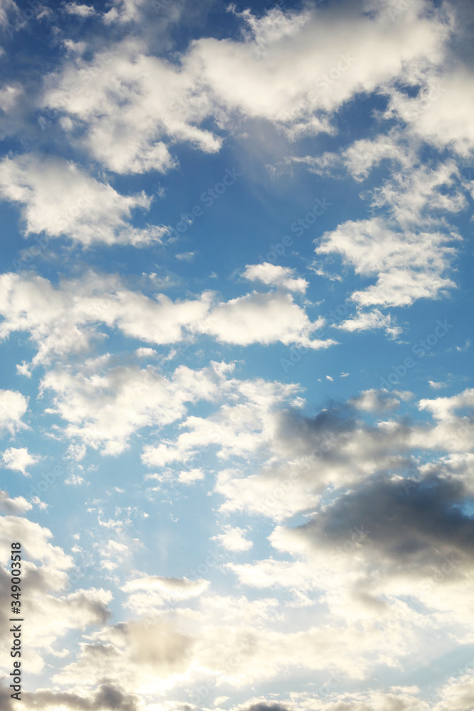 Fototapeta premium Beautiful blue sky with whipped white clouds that are illuminated by the sun