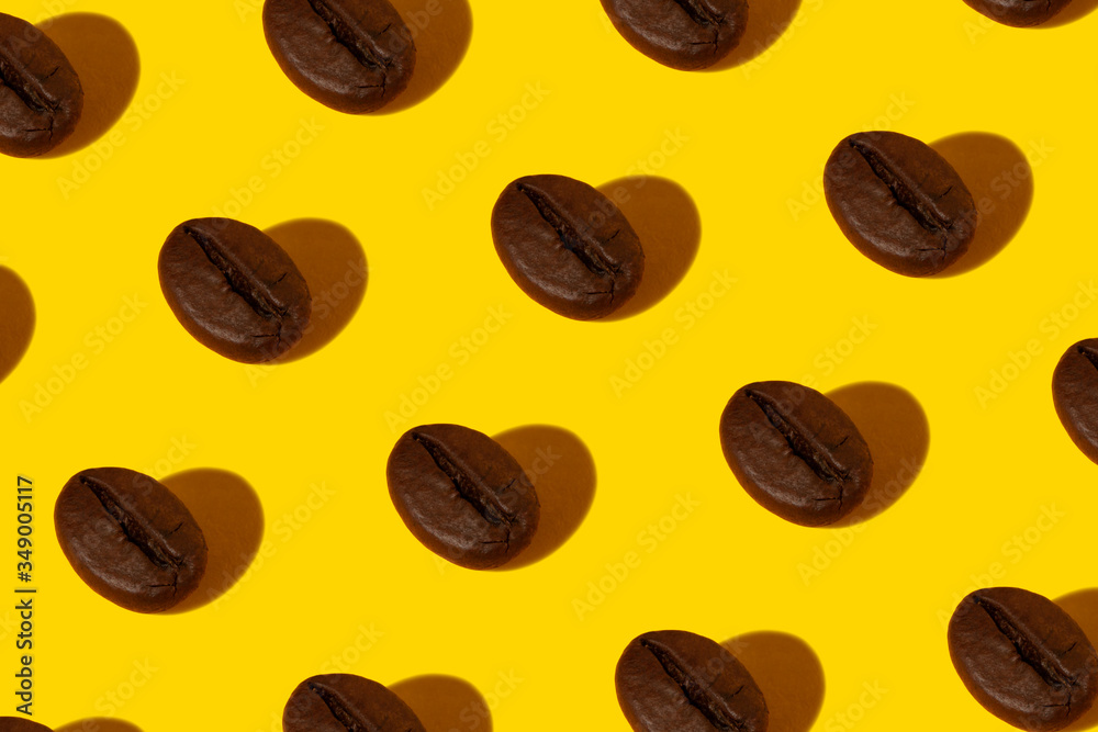 Fototapeta premium Creative bright collage of real macro photos of selected coffee beans on a yellow background with a hard shadow in the shape of a heart.