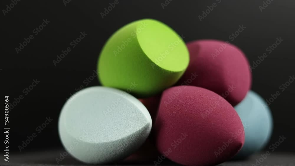 makeup sponges on a black background
