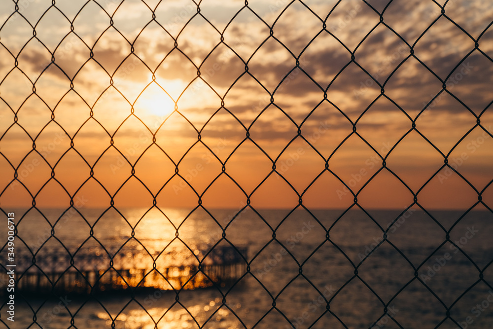 Ocean sunset behind a fence Ocean sunset behind a fence
