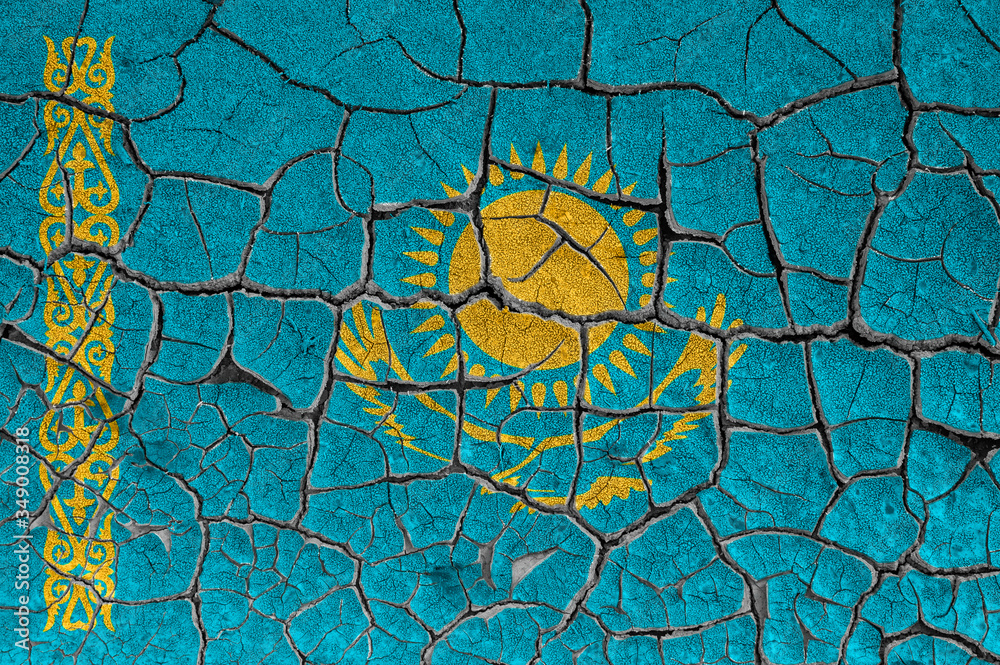 Flag of Kazakhstan on a cracked wall, dry ground
