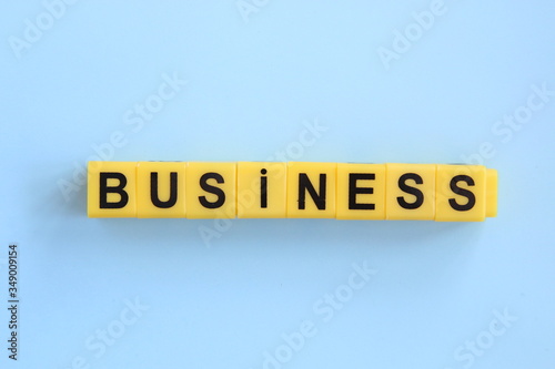 business inscription of yellow cubes on a blue background