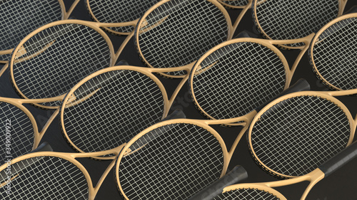 The grid of wooden tennis rackets on black background. 3d render with depth of field. 