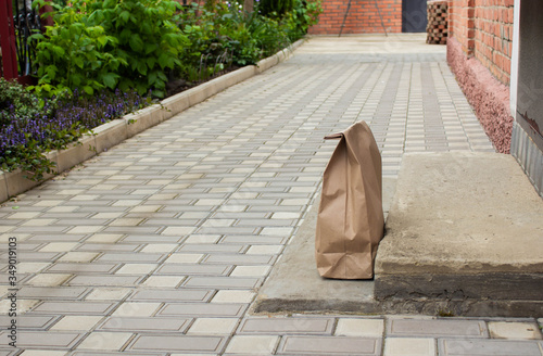 paper bag takeaway food delivery on the doorstep. The concept of service delivery. Space for copying. Advertising zone