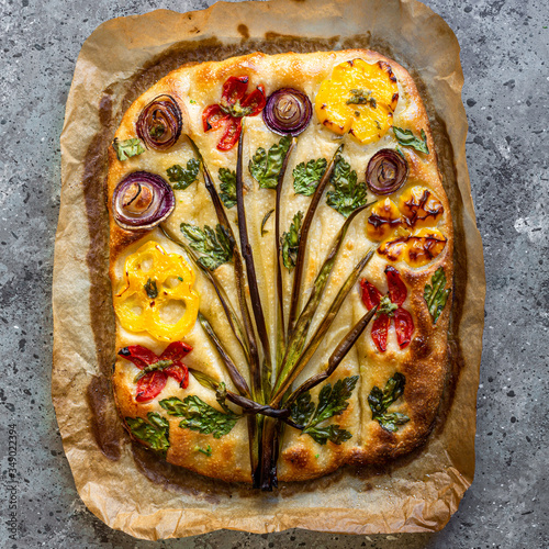 Flower focaccia Creative idea of focaccia cooking. Crispy focaccia with vegetables. Healthy food concept.