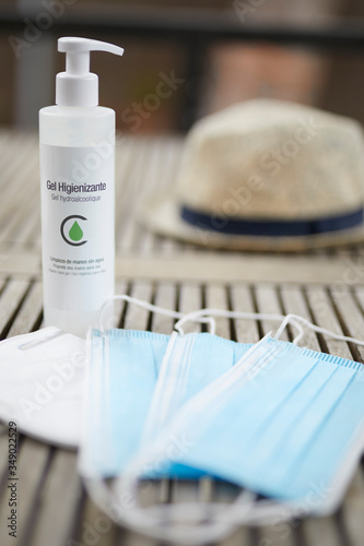 Wallpaper Mural Gel hidroalcoholico con mascarillas de protección sobre mesa de madera. Torontodigital.ca