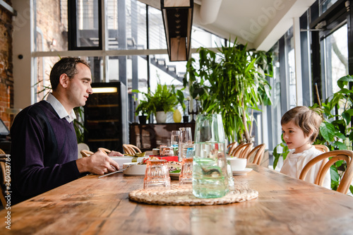 Photos Father and son enjoying time together in a cafe