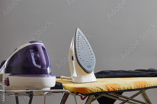 steam generator on the ironing board place for text. photo