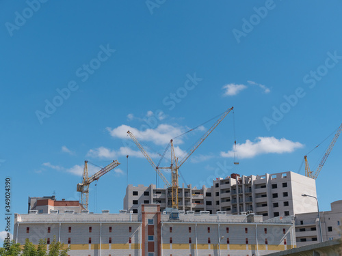 Construction site with many cranes against the sky