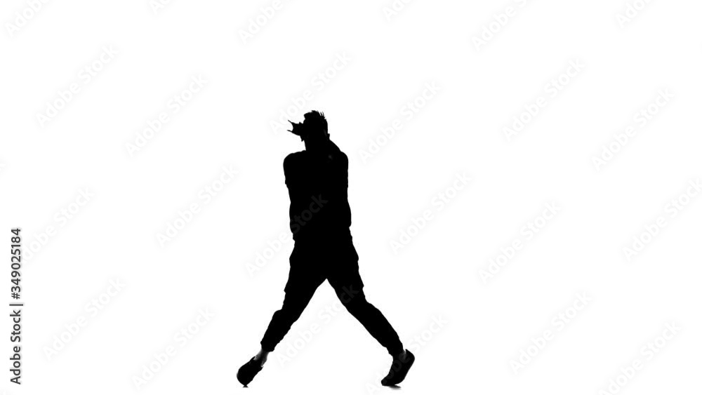 black silhouette on a white background, young handsome man vigorously dancing hip hop, freestyle, street dance, performs complex movements, slow motion black silhouette on a white background, young handsome man vigorously dancing hip hop, freestyle, street dance, performs complex movements, slow motion