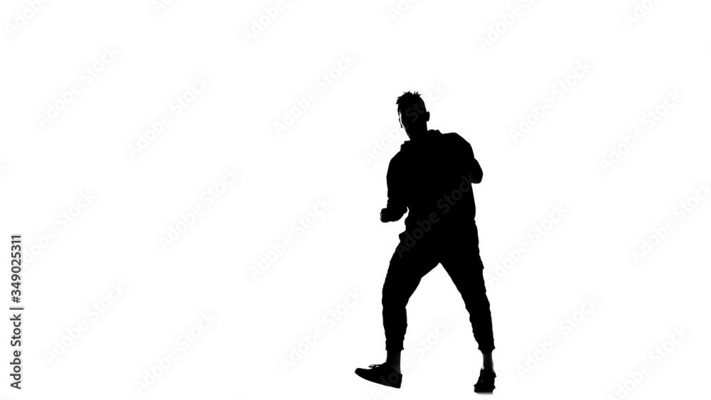 black silhouette on a white background, young handsome man vigorously dancing hip hop, freestyle, street dance, performs complex movements, slow motion