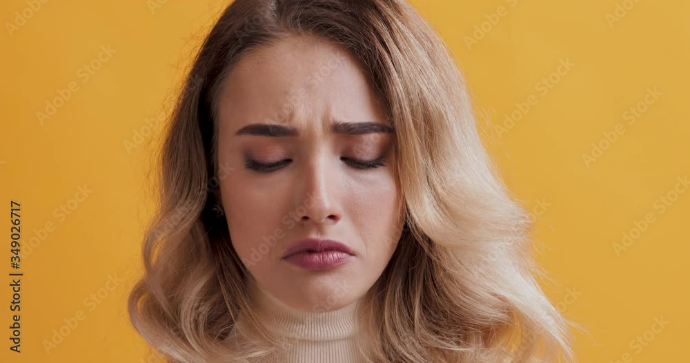 Desperate woman looking at camera with sad facial expression Desperate woman looking at camera with sad facial expression