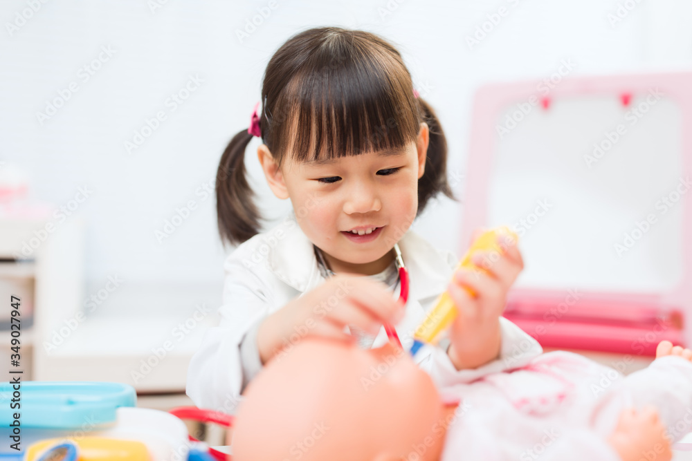 toddler girl pretend play doctor role at home against white background toddler girl pretend play doctor role at home against white background