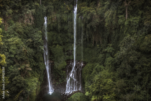Beautiful twin waterfall Sekumpul among lush tropical forest landscape on Bali in Indonesia as famous landmark