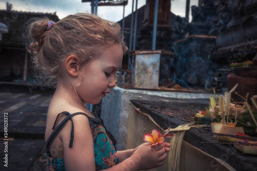 Beautiful child girl praying in temple concept for hope faith and peace 