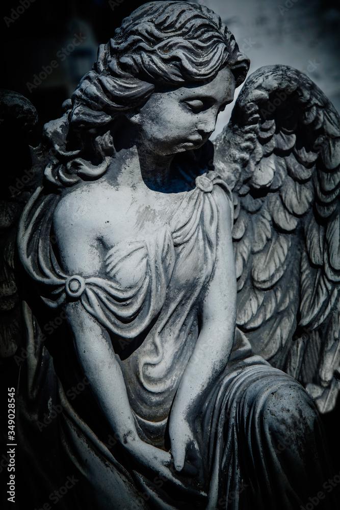 Retro styled image of ancient partially destroyed statue of beautiful angel.