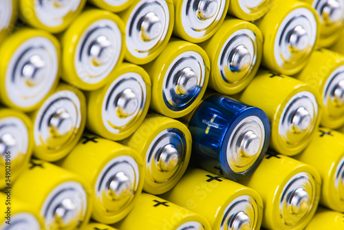 Pile of alkaline batteries with selection focus on single one