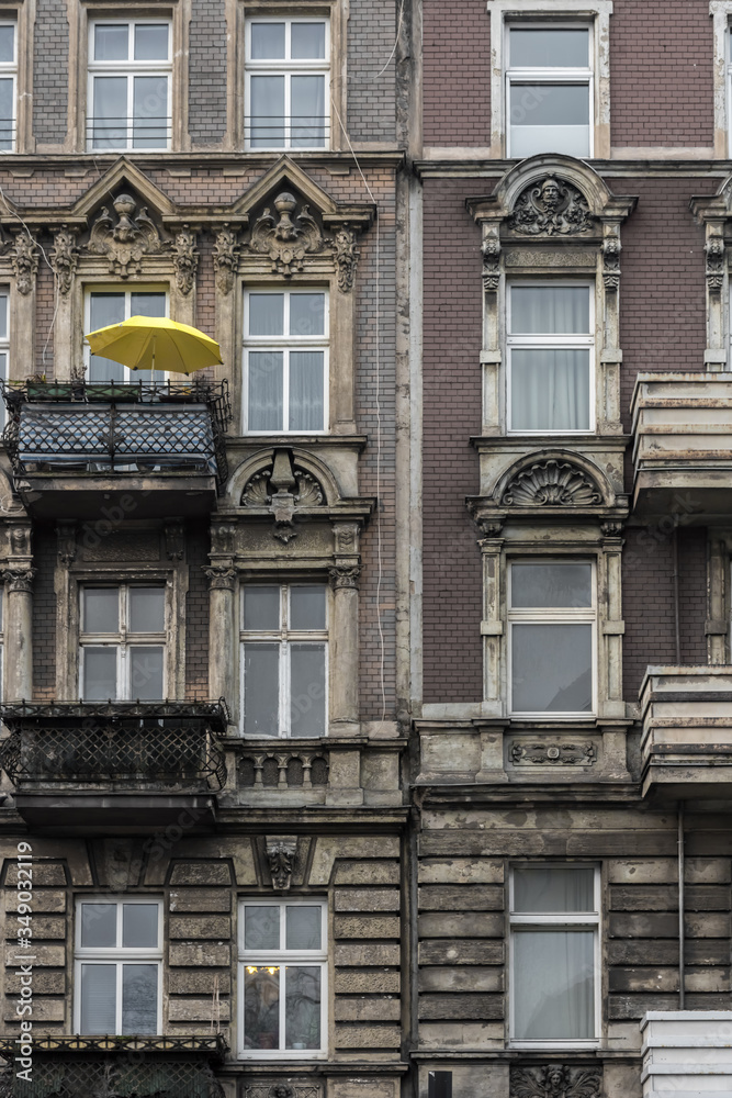 Yellow parasol on a balcony of an old building