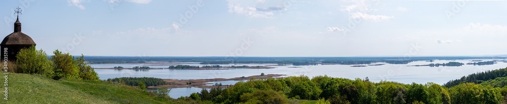 Panorama of Dnieper with old wood church in Vytachiv, Ukraine on May 3, 2020.