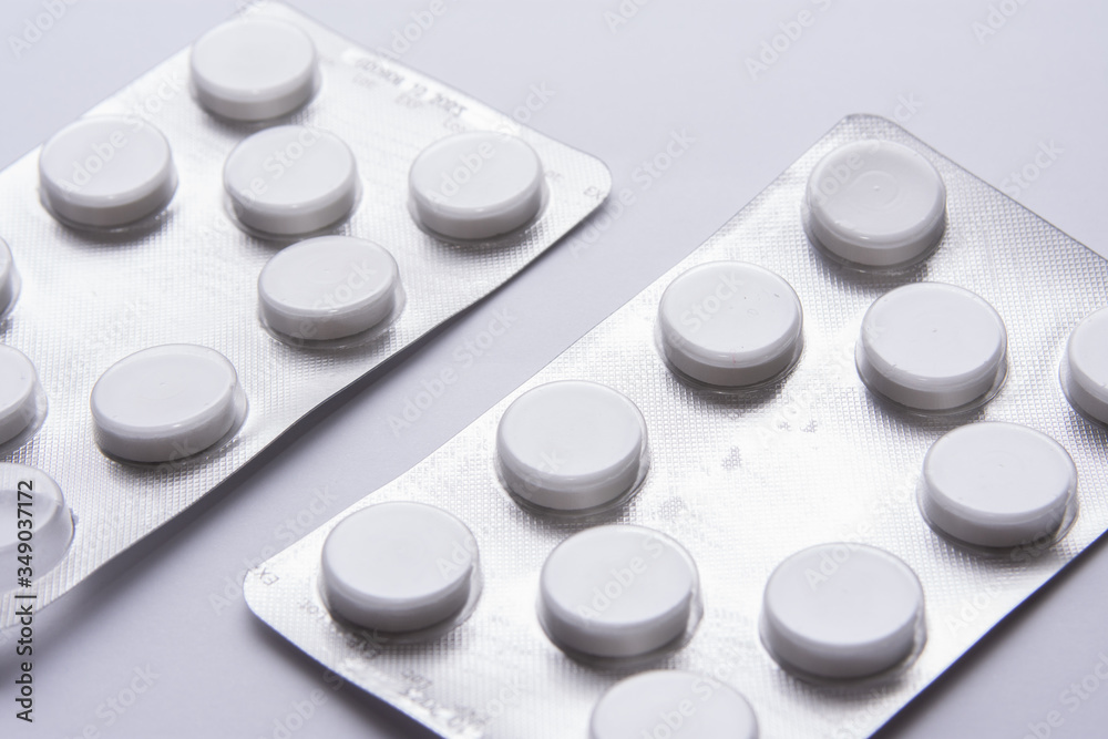 orange pill tablet container lying on grey and silver treatment packages scattered health cure vaccine orange pill tablet container lying on grey and silver treatment packages scattered health cure vaccine