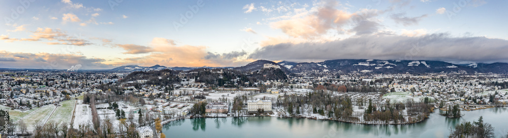 Panoramic aerial drone shot view of Leopoldskroner lake southwest of outskirts of Salzburg during winter