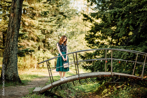 portrait of beautiful young girl in dress on bridge, female portrait outdoors