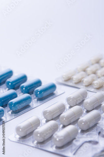 orange pill tablet container lying on grey and silver treatment packages scattered health cure vaccine  © MS Photography