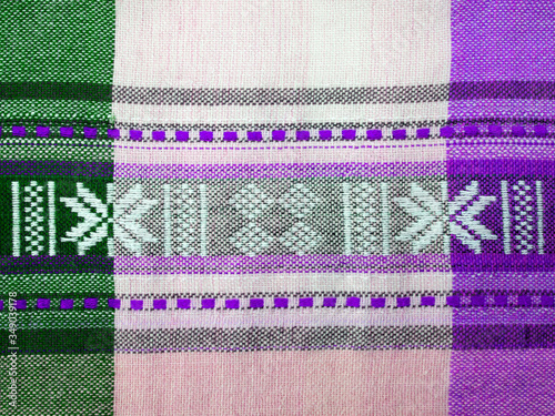 Textile texture in violet, green and white cell. East ornament