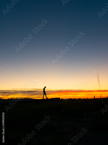Man walking at sunset silhouette 