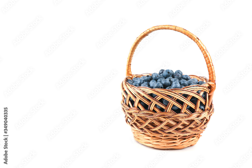blueberry berries in wicker basket isolated on white background