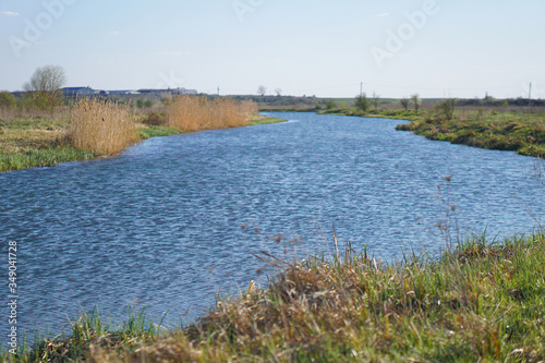 Beautiful spring river in the flowing nature. Colorful landscape in the morning and evening. Travel to deserted places of the world. Stock photo for design