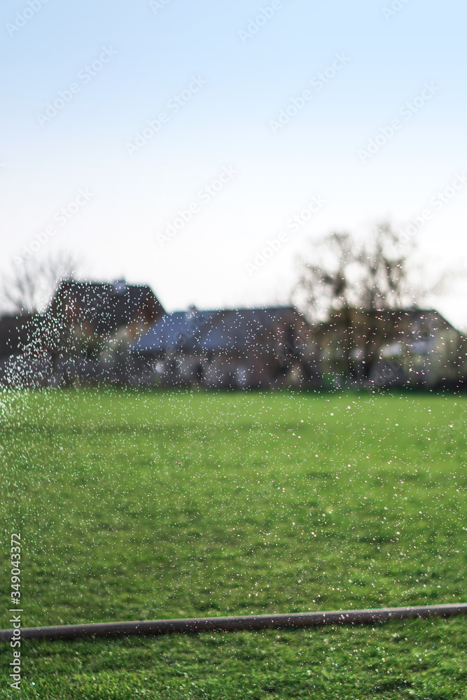 Irrigation system in the field. A broken hose leaks water. Green beautiful background. Village garden Irrigation system in the field. A broken hose leaks water. Green beautiful background. Village garden
