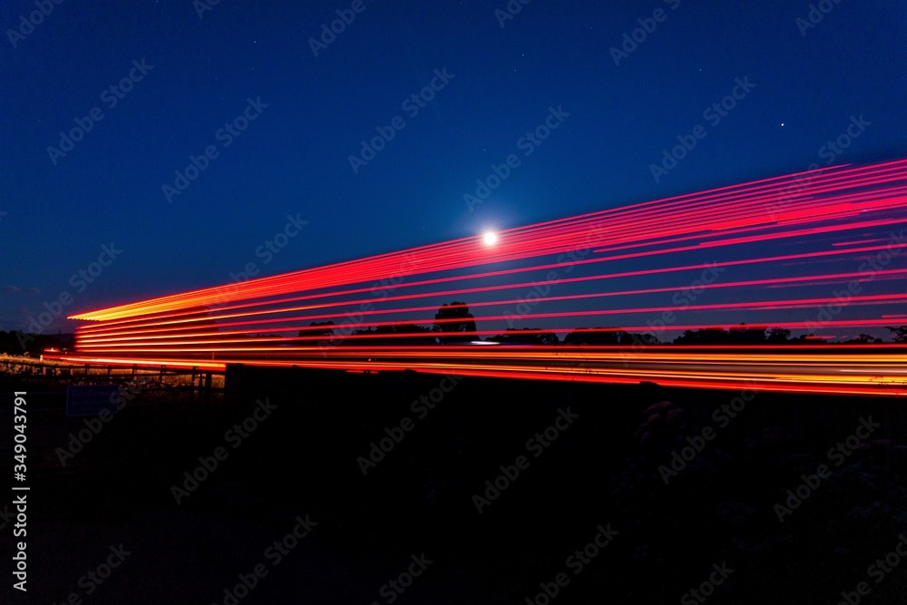Moon shining through the light trails from a wagon on the a66 