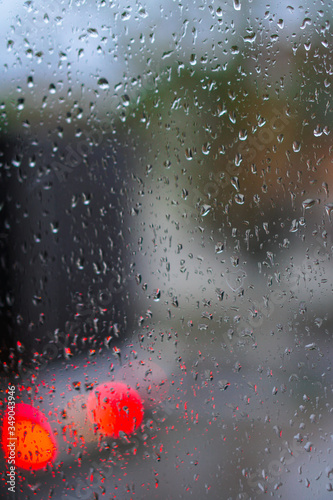 Wallpaper Mural Window overlooking a rainy street. Gloomy evening weather with a view of the road. Drops on glass and bokeh from cars. Stock background for design Torontodigital.ca