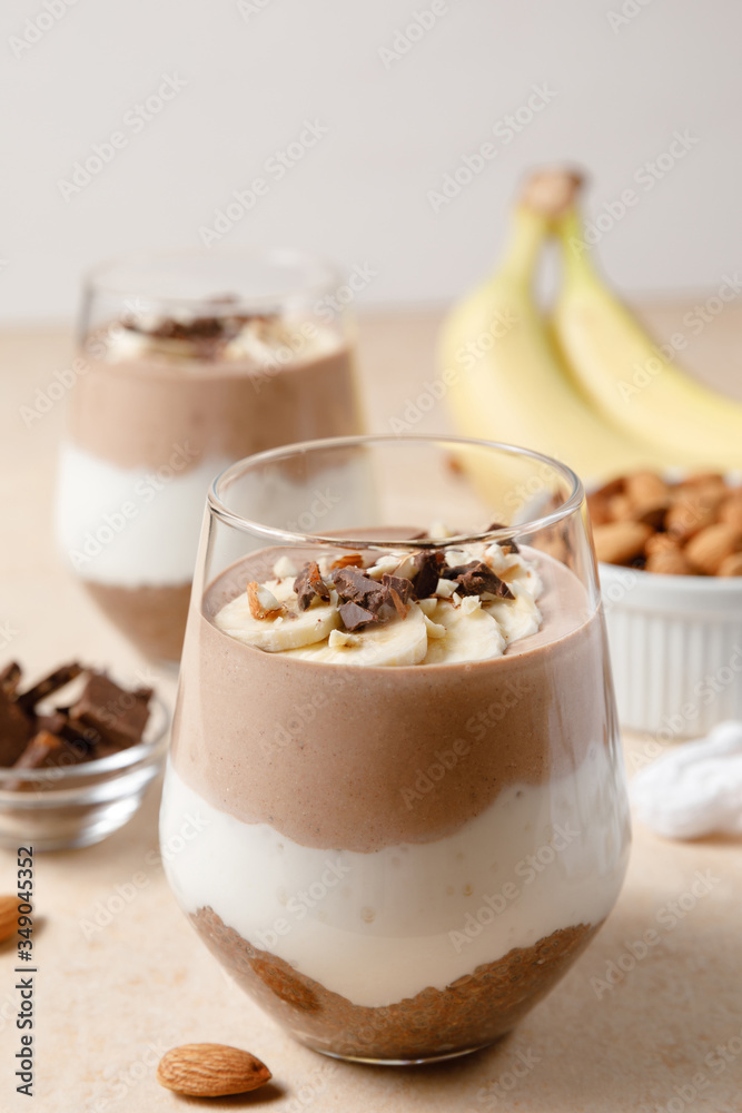 Chia seeds pudding with chocolate and banana smoothie in a glass Chia seeds pudding with chocolate and banana smoothie in a glass