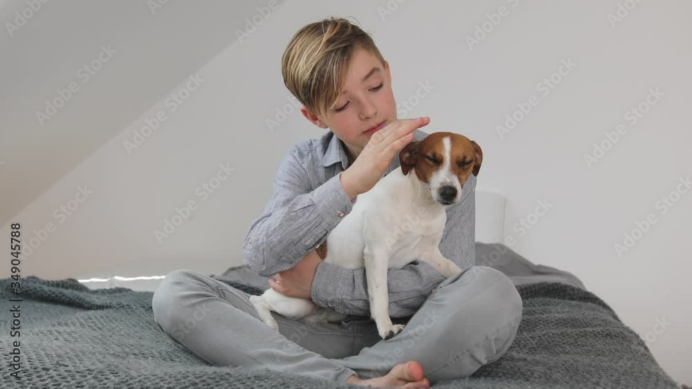 Young boy cuddling his dog at home Young boy cuddling his dog at home
