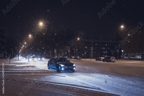 Night winter snowy road with cars