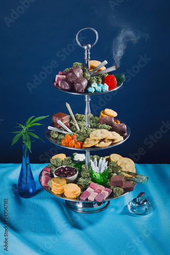 Fancy Tower of Cannabis Edibles with Leaves in Vase and Joints Smoking (ID: 349047181)