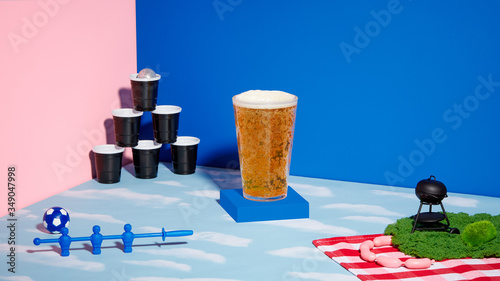 Pint of Beer on Conceptual Set with Beer Pong, Foosball, Grilling and Clouds Horizontal (ID: 349047998)