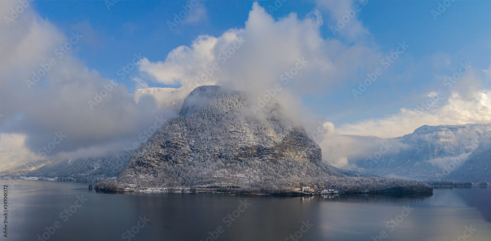 Panorama view of Hallstattersee lake and mountain in daylight with snow. Landscape view of famous Hallstatt lakeside town during winter. Salzkammergut region, Austria. Januyary2020 Panorama view of Hallstattersee lake and mountain in daylight with snow. Landscape view of famous Hallstatt lakeside town during winter. Salzkammergut region, Austria. Januyary2020