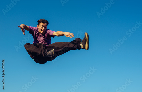 Young man performing a flying kick