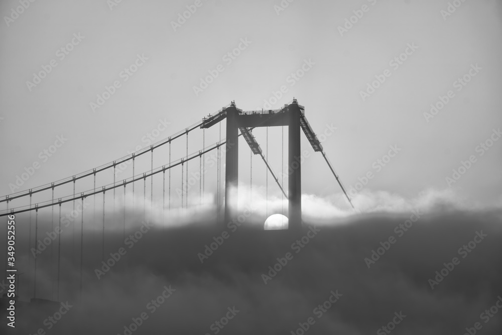 Fototapeta premium Foggy and Misty scene of Bosphorus Bridge. Bridge over the Bosphorus in Istanbul. View from the Asian part of Istanbul. The 15 July Martyrs Bridge in a fog