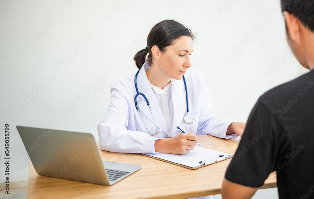 Medical Doctor is Working in Hospital Examination Room, Female Physician Doctor is Diagnosing Physical Health Check Up for Patients. Medicine/Healthcare Concept Medical Doctor is Working in Hospital Examination Room, Female Physician Doctor is Diagnosing Physical Health Check Up for Patients. Medicine/Healthcare Concept