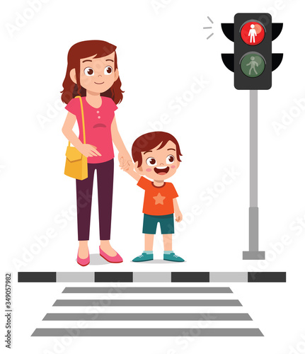 happy cute little kid boy cross the road with mother