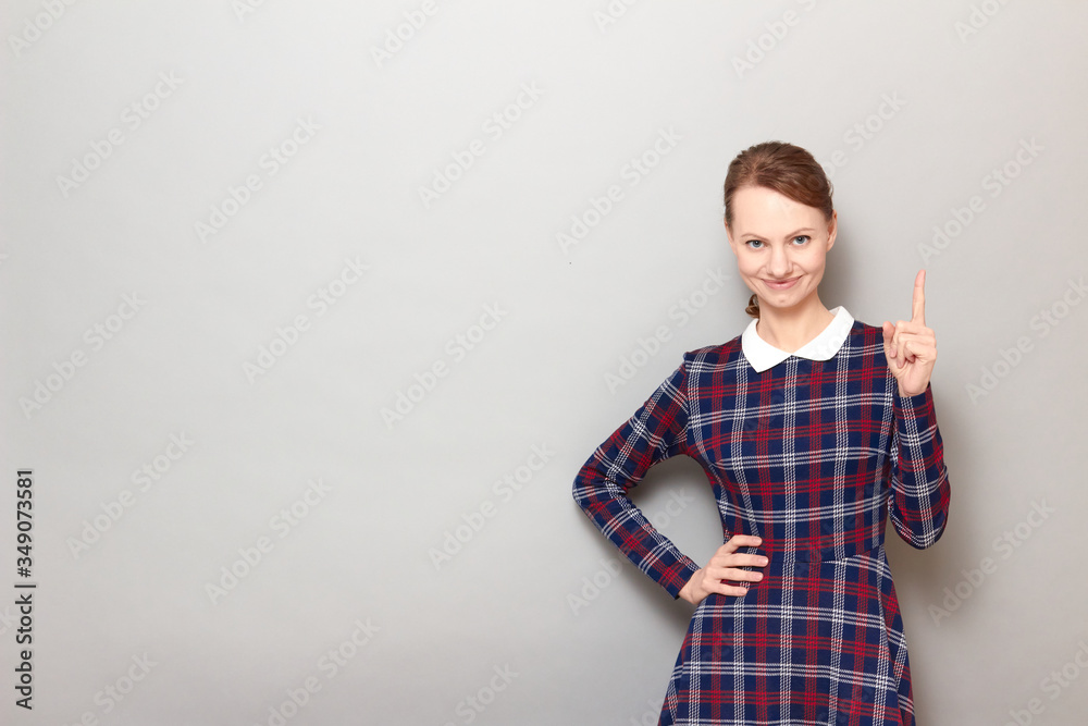 Portrait of happy girl pointing up with finger and smiling Portrait of happy girl pointing up with finger and smiling