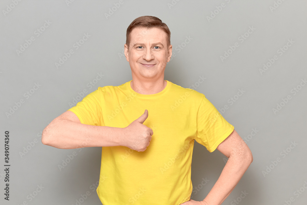Portrait of happy joyful mature man raising thumb up Portrait of happy joyful mature man raising thumb up
