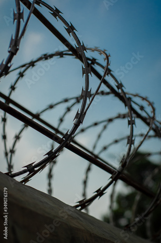 barbed wire against blue sky