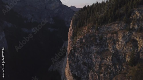 Evening light glow on sheer cliff faces at sunset. Wild Ferenc, or Ferencz, is popular portion of Via Ferrata in Romania famous for rock climbing and outdoor adventure extreme sports. photo